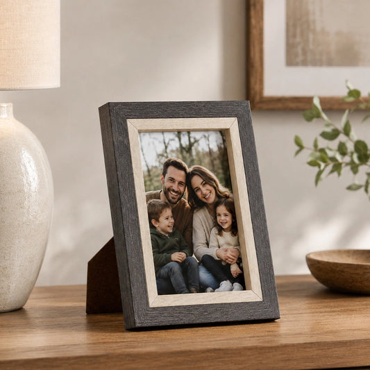 Grey wooden photo frame with natural finish on side table