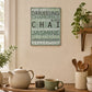 Wooden kitchen wall plaque featuring different tea varieties displayed above a kitchen worktop