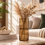 Large brown glass vase with dried pampas and foliage styled on a living room coffee table