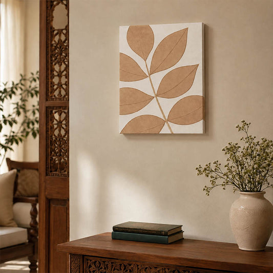 Neutral leaf design wall art in beige and white styled above a carved wooden console table