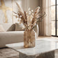 Medium grey ribbed glass vase with pampas grass and dried foliage on a marble coffee table