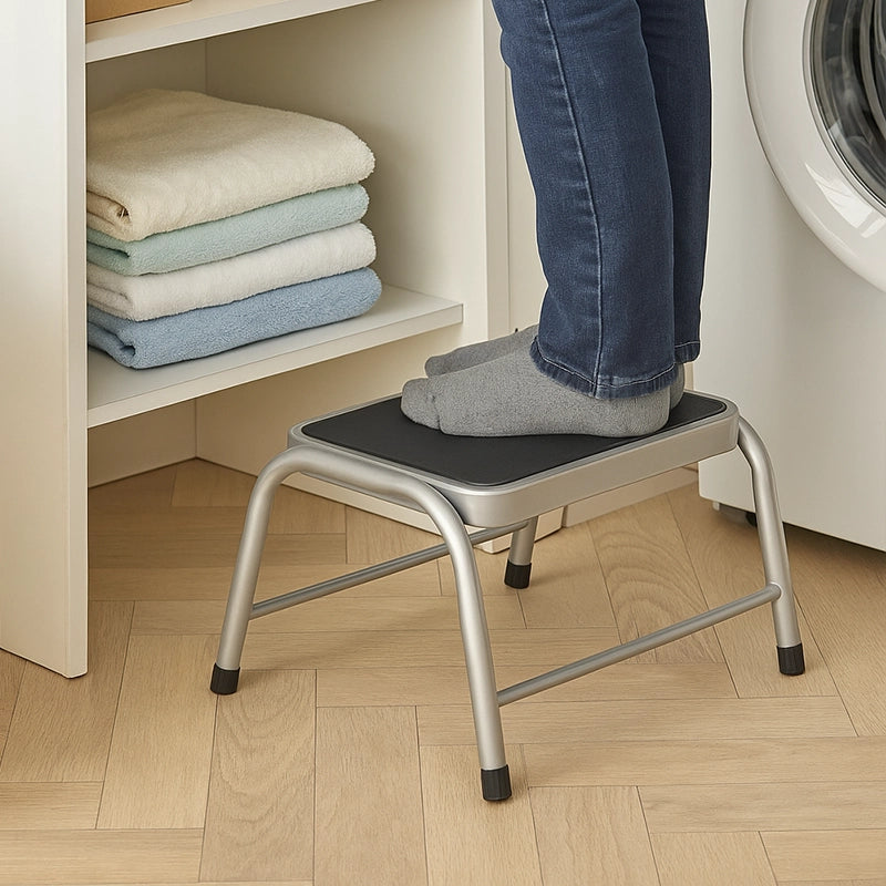 Metal step stool with non-slip top used for reaching laundry shelves