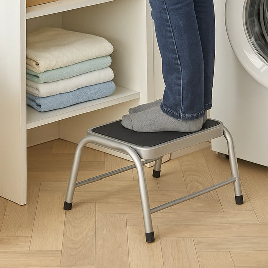Metal step stool with non-slip top used for reaching laundry shelves