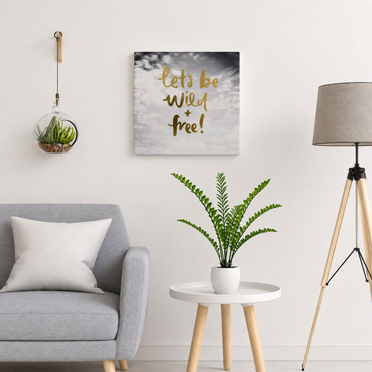 Motivational wall plaque with “Let’s Be Wild & Free” quote displayed above a side table