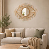 Natural rattan eye shape wall mirror above sofa in living room