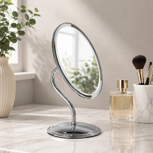 Silver oval swivel mirror on vanity table with makeup brushes