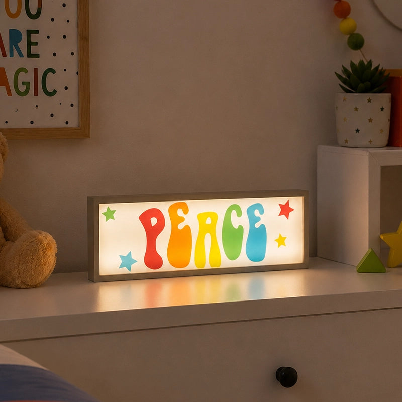 Peace LED light box with colourful letters on kids bedroom dresser