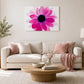 Pink floral wall art featuring a bold flower design displayed above a neutral living room sofa