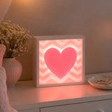 Pink heart LED light box on bedroom dresser with soft warm glow