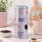 Pink storage canister with lid and colourful printed design displayed on a kitchen worktop