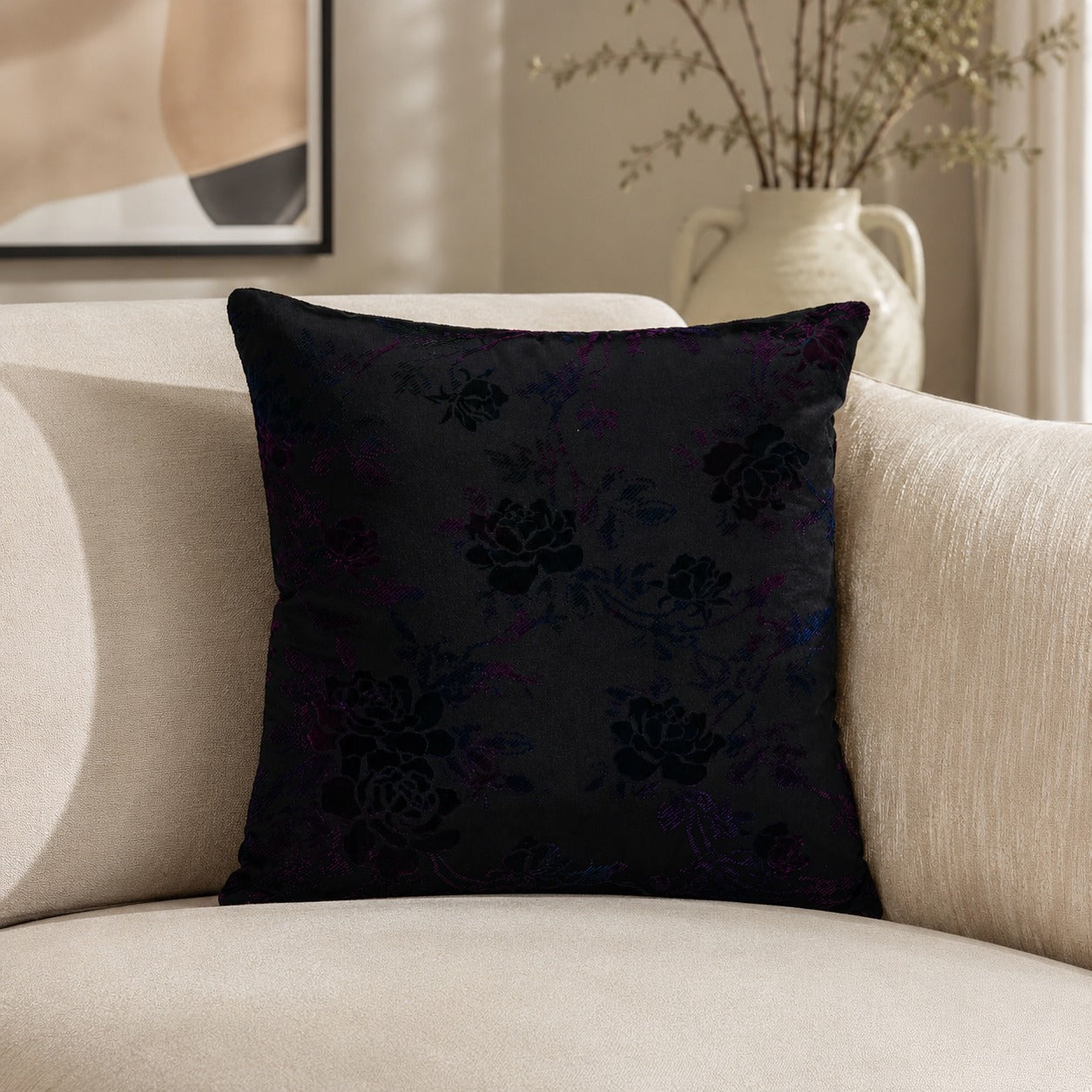 Deep purple patterned cushion displayed on a light upholstered armchair