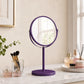 Purple round swivel mirror on bathroom vanity with toiletries