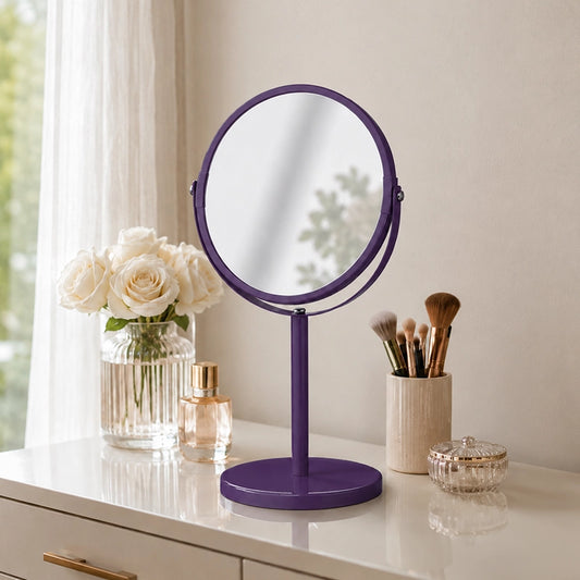 Purple swivel table mirror on vanity with makeup brushes