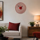 Red metal wall clock above sofa with red cushion and side lamp