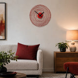 Red metal wall clock above sofa with red cushion and side lamp
