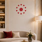 Red plastic heart wall clock above sofa in warm living room setting