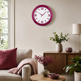 Red plastic wall clock above sofa in warm living room decor