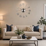 Silver metal wall clock with Roman numerals above living room sofa
