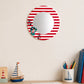 Red striped round wall mirror above desk with pencils and decor