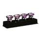 Set of four purple diamante napkin rings with faceted crystal tops in a black presentation holder