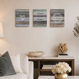Set of three decorative wooden wall plaques with motivational quotes displayed above a console table