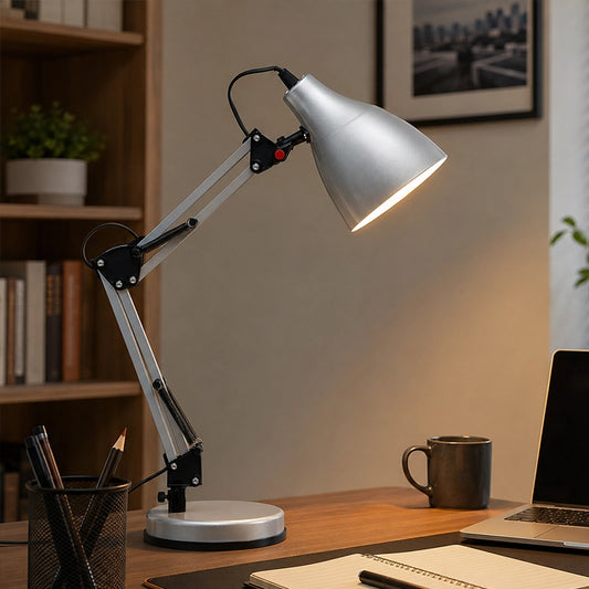 Silver adjustable desk lamp on office desk with mug and stationery