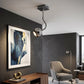 Silver metal ceiling light with curved arm and globe shade in modern living room interior