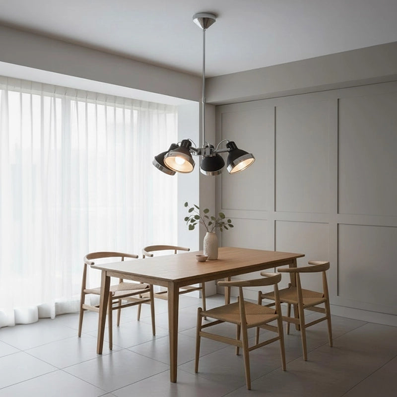 Silver and black pendant light above wooden dining table