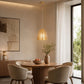 Small gold pendant light hanging above round dining table in modern room