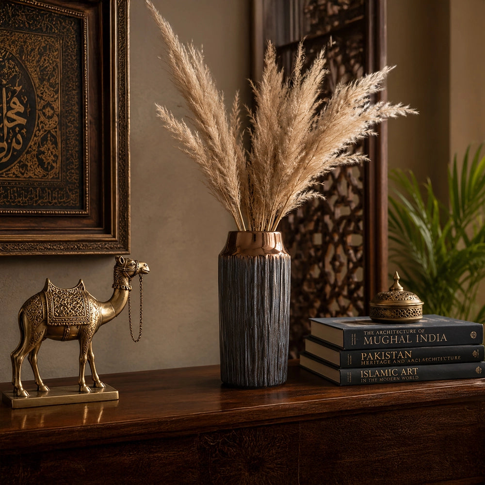 Small grey decorative vase with tall dried pampas grass styled on a wooden console table
