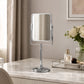 Silver square dressing table mirror on marble vanity with perfume and flowers