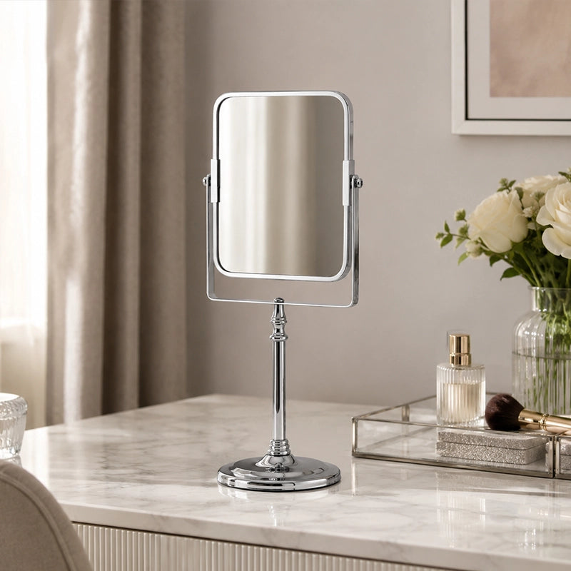 Silver square dressing table mirror on marble vanity with perfume and flowers