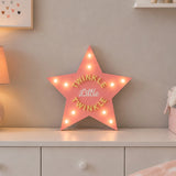 Star shaped LED marquee light on children’s bedroom dresser