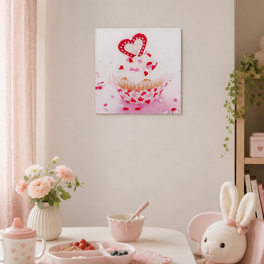 Pink cupcake glass wall art with heart detail displayed in a pastel dining and kitchen setting