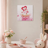 Pink cupcake glass wall art with heart detail displayed in a pastel dining and kitchen setting