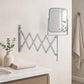 Wall mounted extendable mirror beside bathroom sink and toothbrush holder