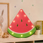 Watermelon LED light box on kids room shelf with soft glowing bulbs