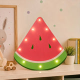 Watermelon LED light box on kids room shelf with soft glowing bulbs