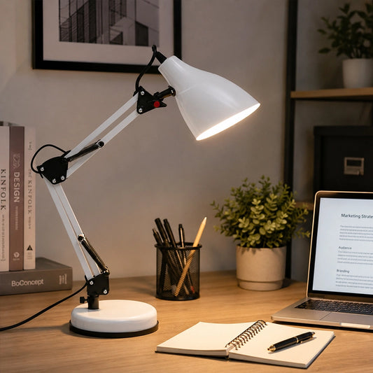 White adjustable desk lamp on wooden office desk with notebook and laptop