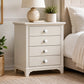White round drawer knobs fitted to a white bedside chest of drawers