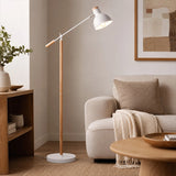 White floor lamp beside sofa in modern living room corner
