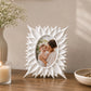 White floral photo frame with sunburst border displaying portrait