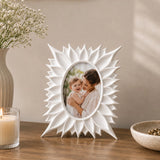 White floral photo frame with sunburst border displaying portrait