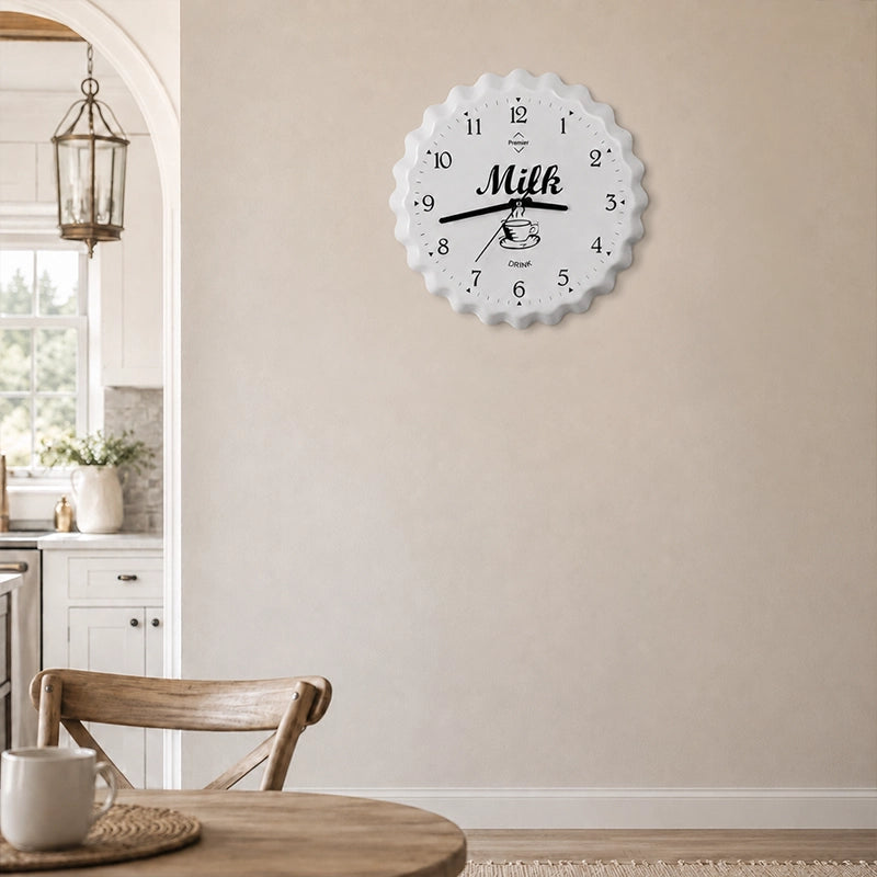 White metal wall clock with milk design and black numbers in kitchen dining area