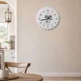 White metal wall clock with milk design and black numbers in kitchen dining area