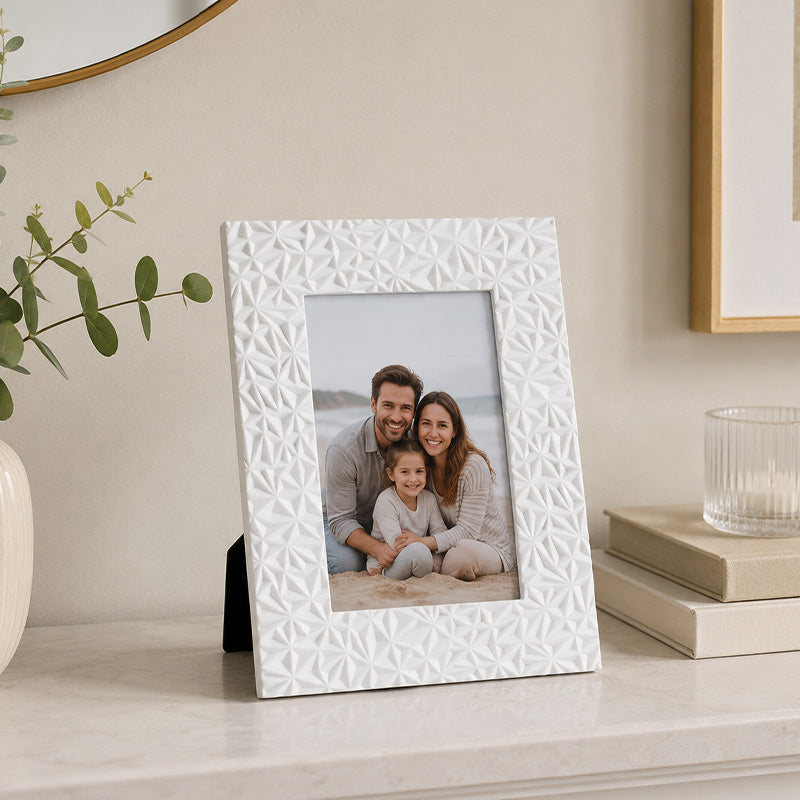 White picture frame with textured pattern displaying family photograph