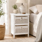 White bedside storage unit with two maize baskets, lamp and neutral bedroom decor