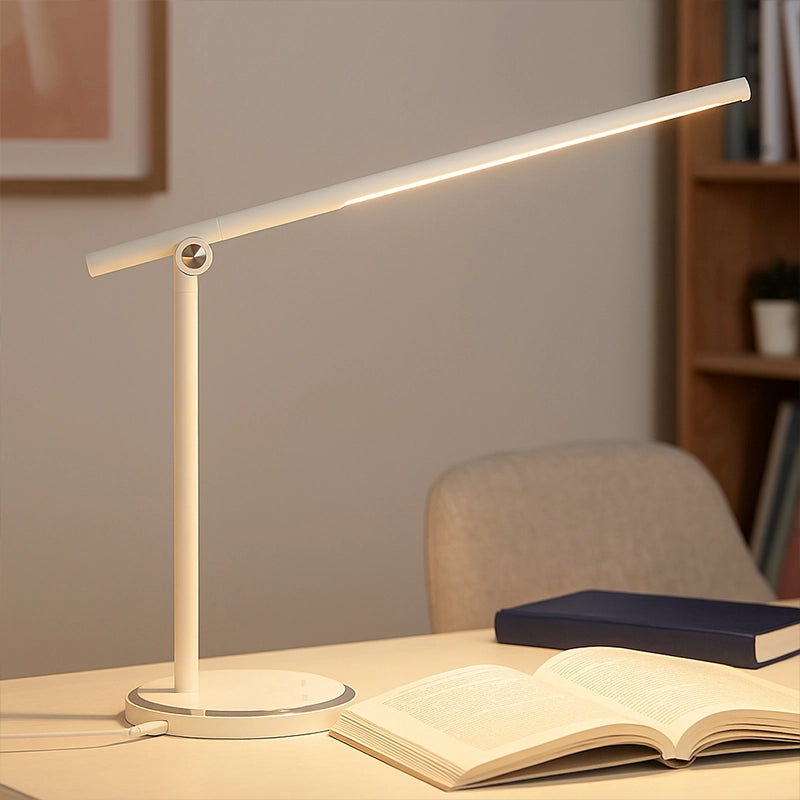 White touch lamp with slim LED bar on desk beside open book