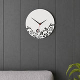 White wall clock with black floral pattern on dark grey panel wall