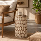 Decorative round accent table with wood slice design in neutral living room